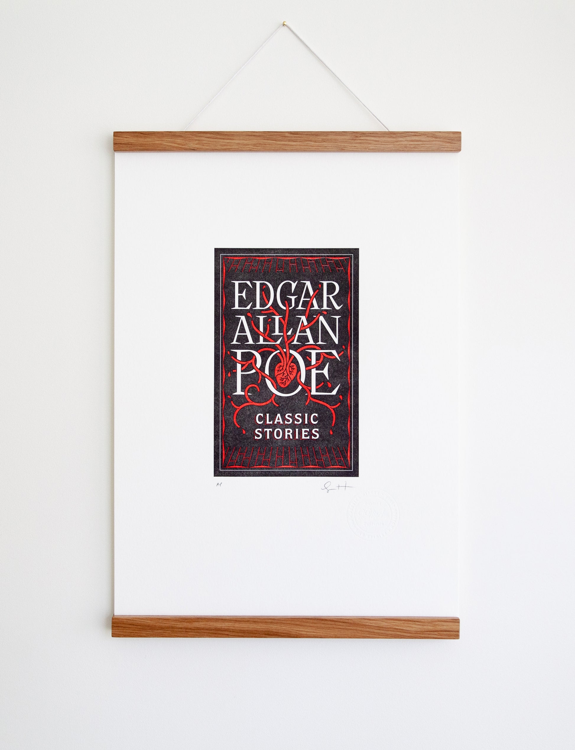 Framed 2-color letterpress print in black and red. Printed artwork is an illustrated book cover of Edgar Allan Poe including custom hand lettering.