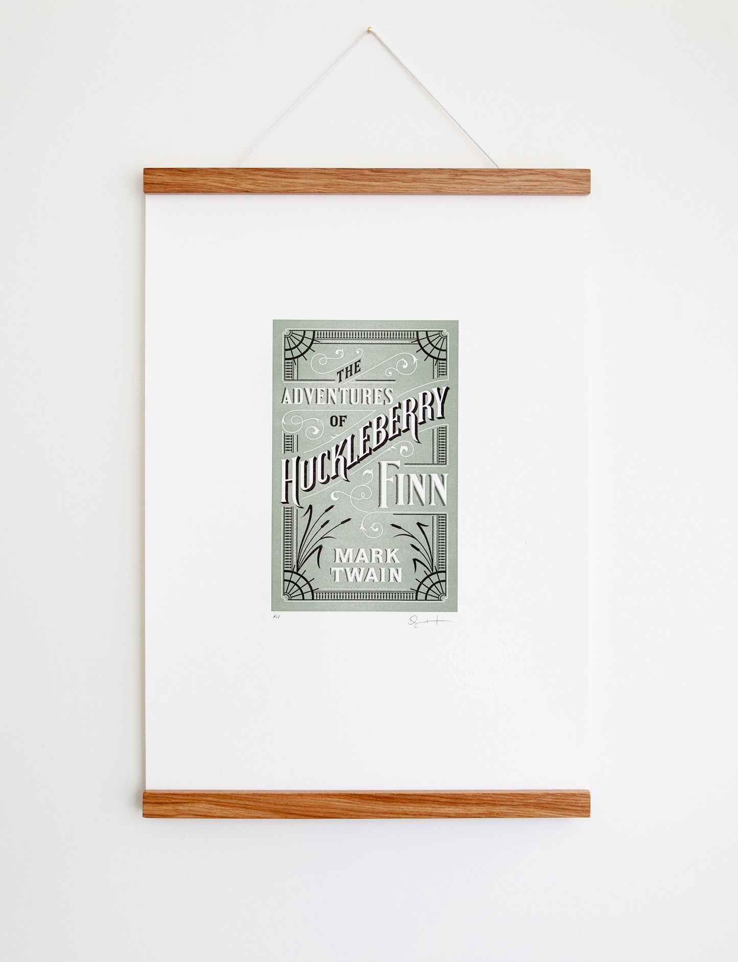 Framed 2-color letterpress print in green and black. Printed artwork is an illustrated book cover of The Adventures of Huckleberry Finn including custom hand lettering.