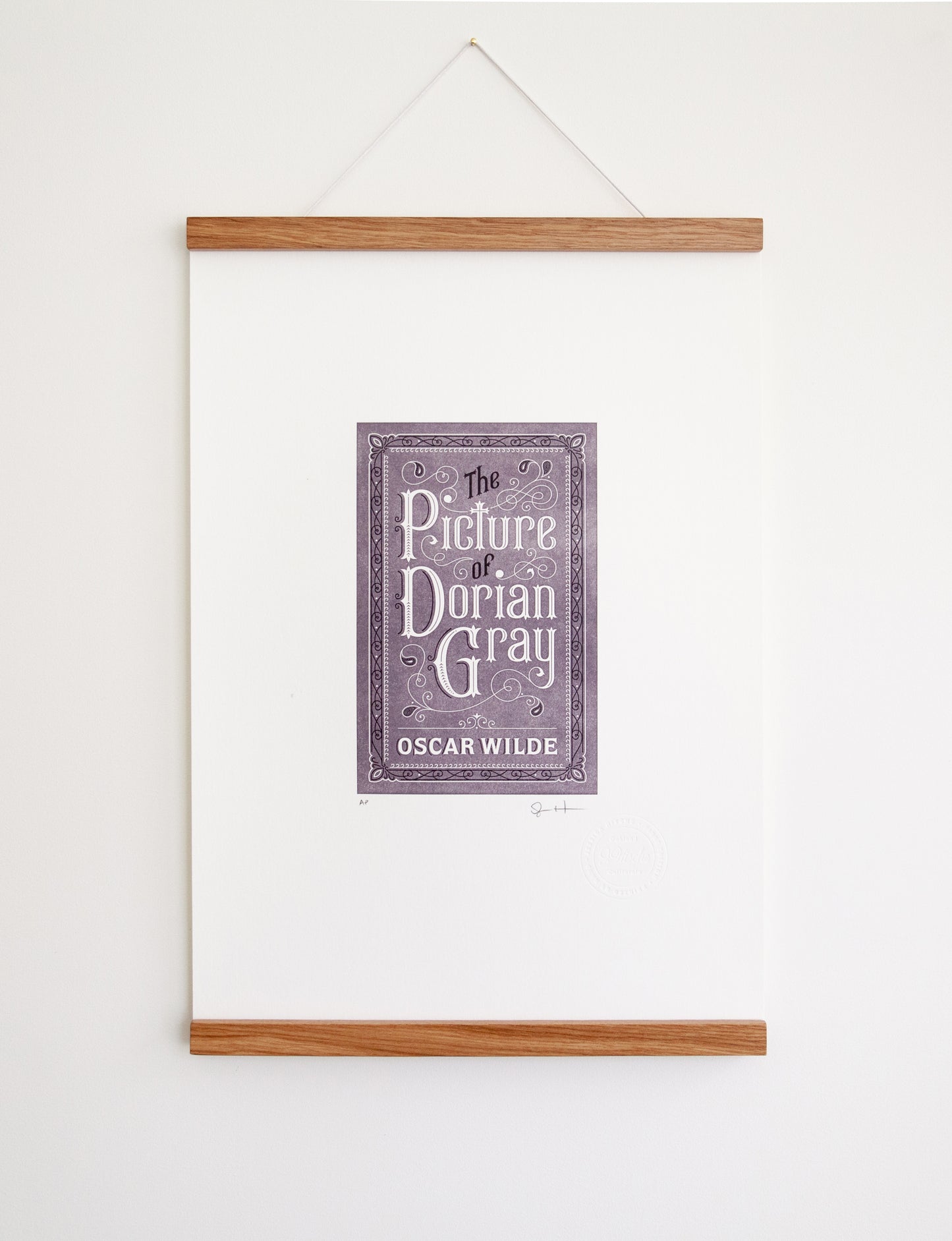 Framed 2-color letterpress print in violet and black. Printed artwork is an illustrated book cover of The Picture of Dorian Gray including custom hand lettering.