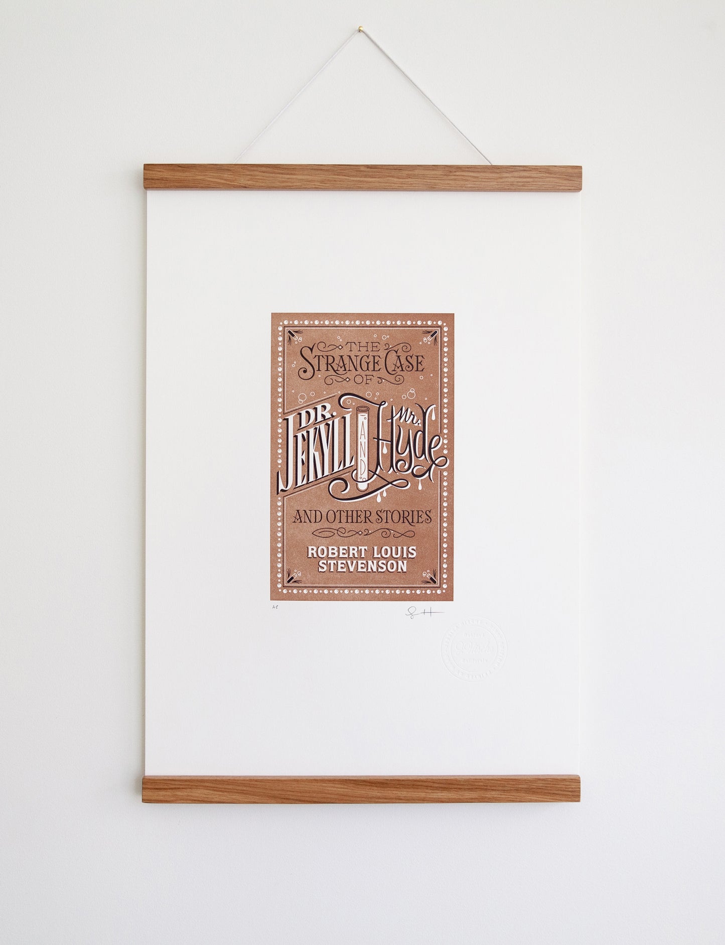 Framed 2-color letterpress print in brown and black. Printed artwork is an illustrated book cover of Dr. Jekyll and Mr. Hyde including custom hand lettering.