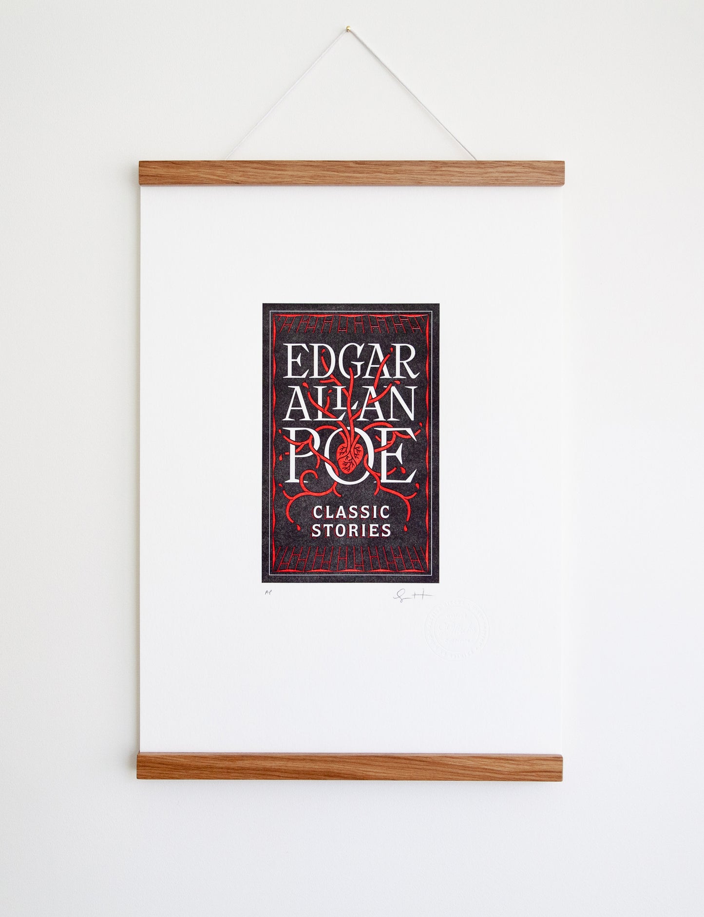 Framed 2-color letterpress print in black and red. Printed artwork is an illustrated book cover of Edgar Allan Poe including custom hand lettering.