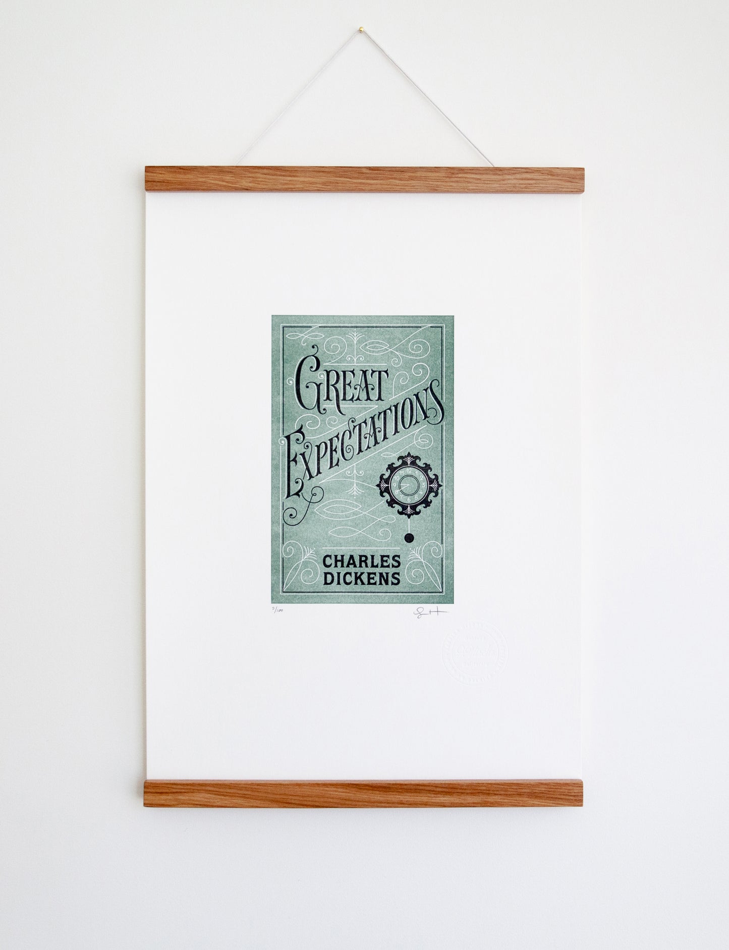 Framed 2-color letterpress print in green and black. Printed artwork is an illustrated book cover of Great Expectations including custom hand lettering.