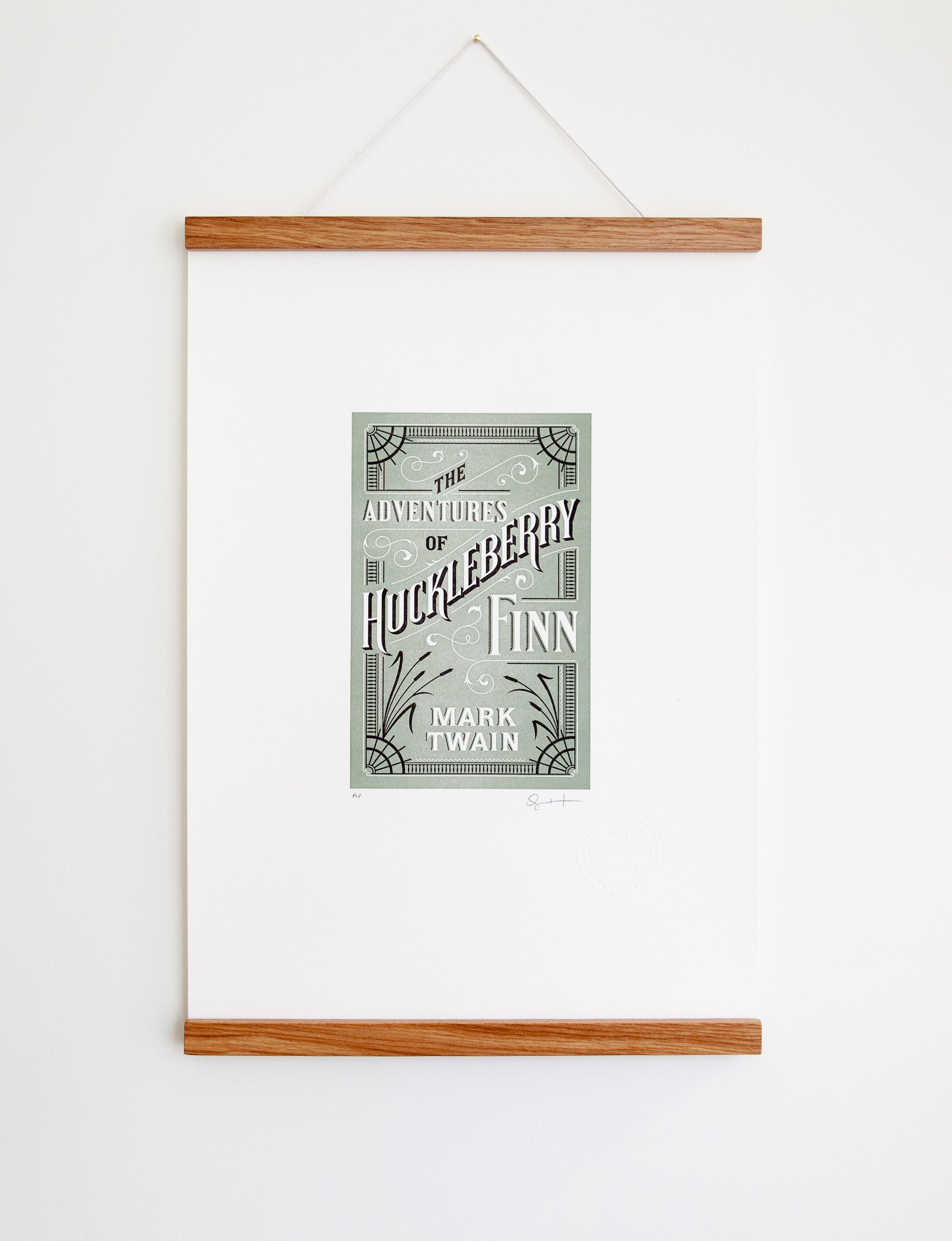 Framed 2-color letterpress print in green and black. Printed artwork is an illustrated book cover of The Adventures of Huckleberry Finn including custom hand lettering.