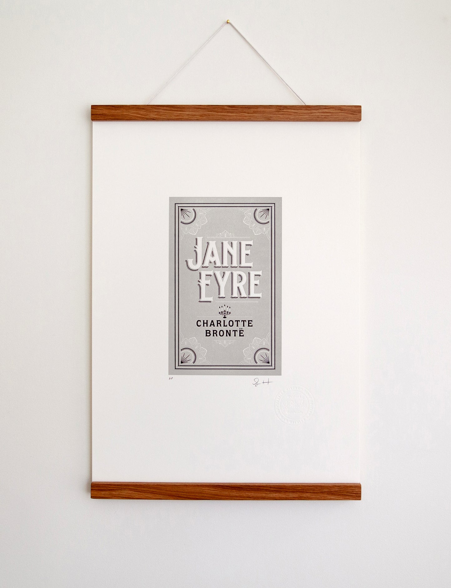 Framed 2-color letterpress print in gray and black. Printed artwork is an illustrated book cover of Jane Eyre including custom hand lettering.