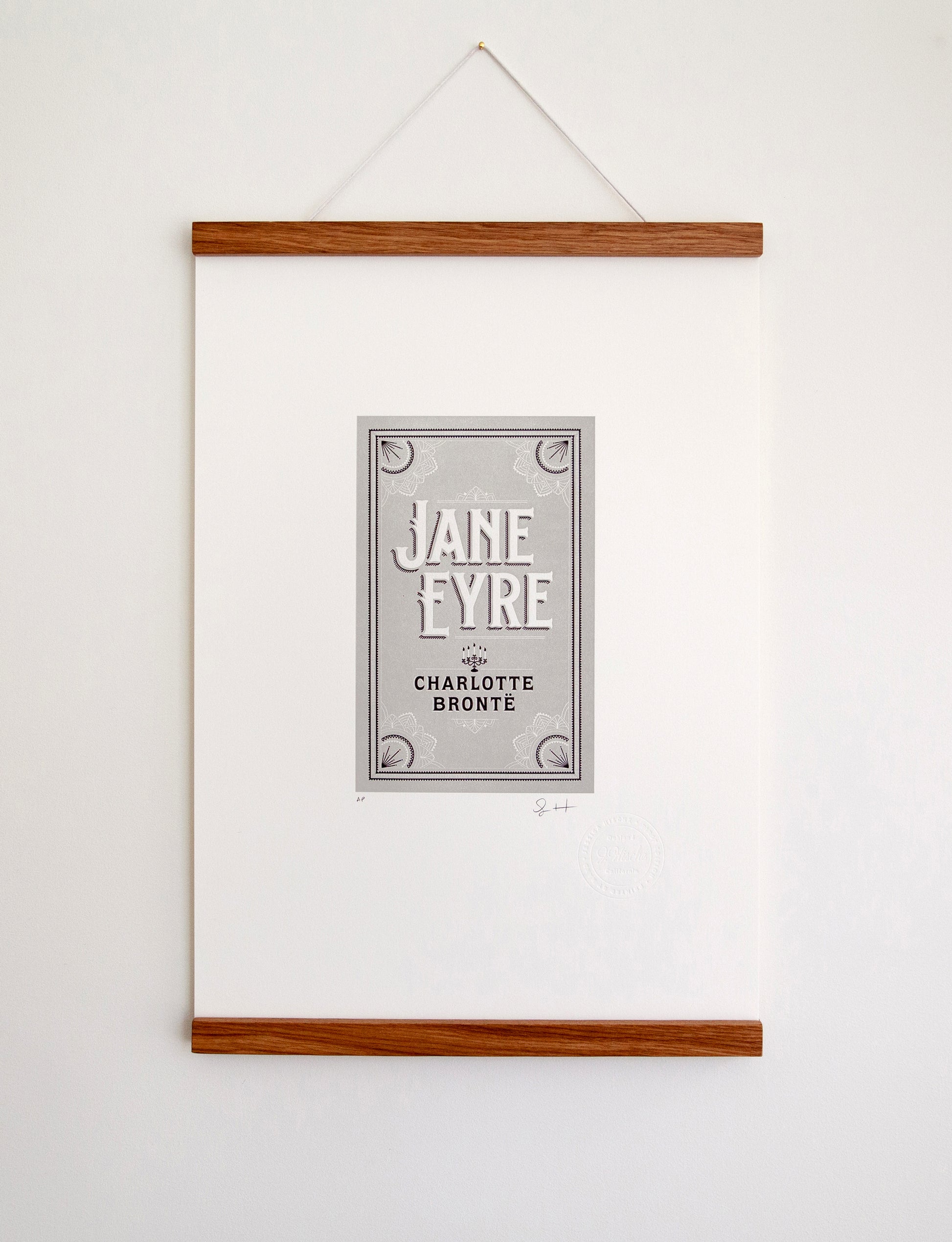 Framed 2-color letterpress print in gray and black. Printed artwork is an illustrated book cover of Jane Eyre including custom hand lettering.