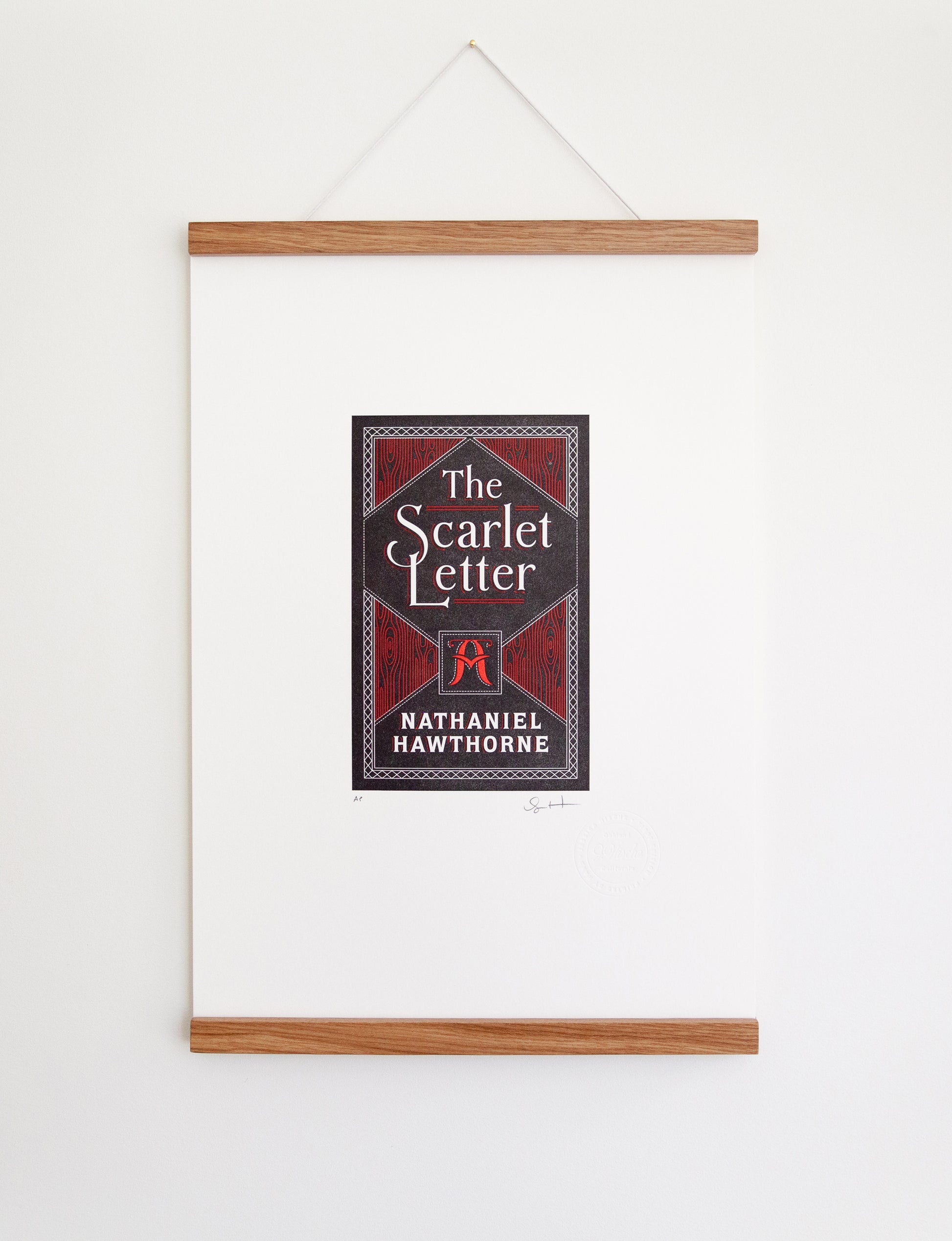 Framed 2-color letterpress print in black and red. Printed artwork is an illustrated book cover of The Scarlet Letter including custom hand lettering.