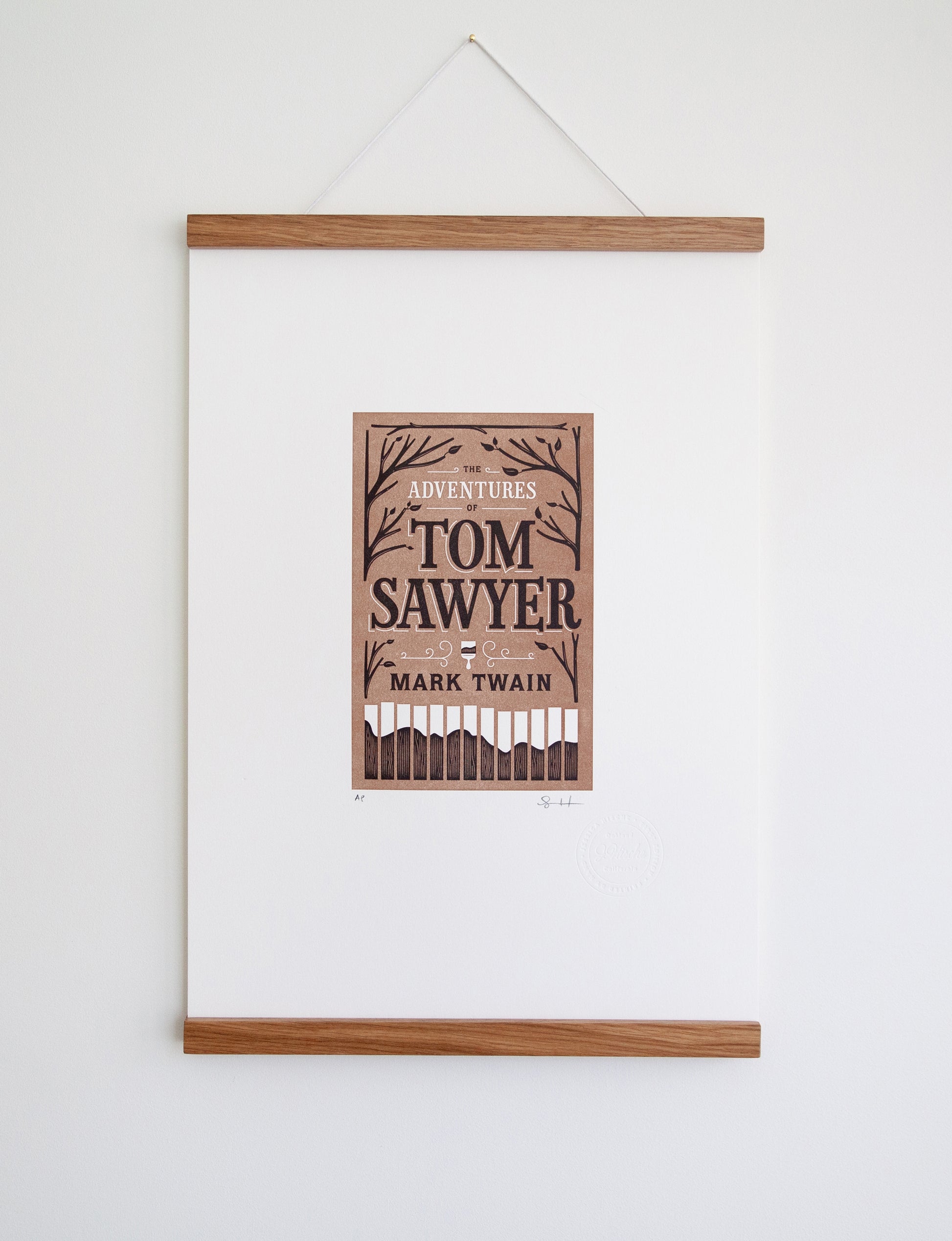 Framed 2-color letterpress print in brown and black. Printed artwork is an illustrated book cover of The Adventures of Tom Sawyer including custom hand lettering.